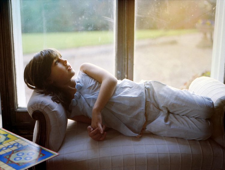 Girl relaxes on a chaise longue, Somerset, UK, 2008 Girl relaxes on a chaise longue, Somerset, UK, 2008
